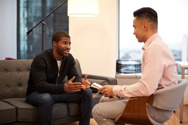 man speaking with therapist about mental health and addiction treatment